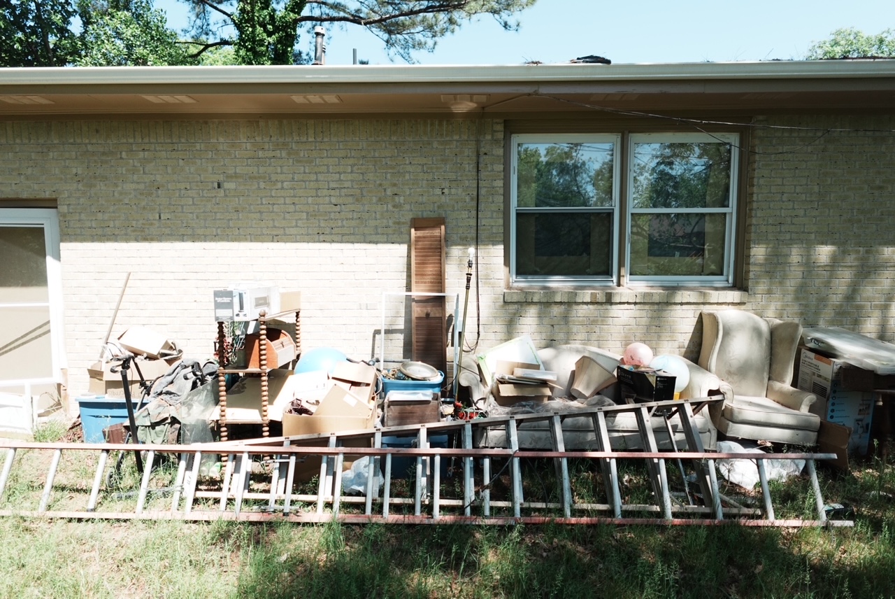Side-yard junk pile cleanup — before